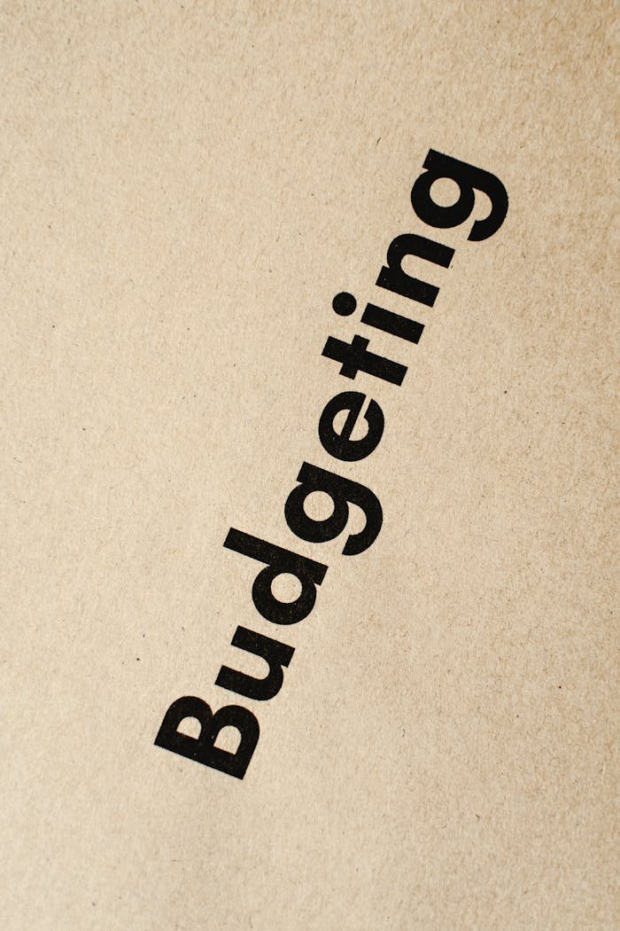 Detailed close-up of the word 'Budgeting' printed on brown textured paper.